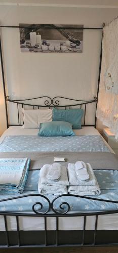 a bed with two towels and two pillows on it at Chambre Zen Et Calme in Bouveret