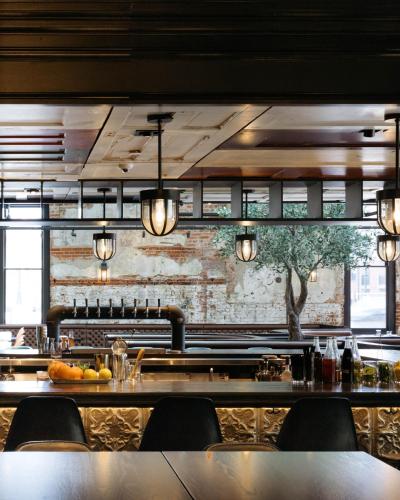a bar in a restaurant with a brick wall at Hilton Garden Inn Denver Union Station in Denver