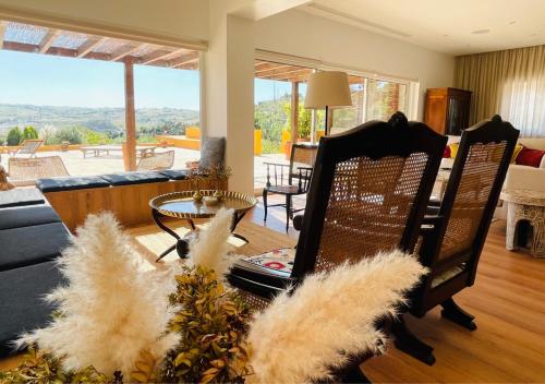 a living room with a couch and a table and chairs at Pomar da Choca Country House in Alenquer