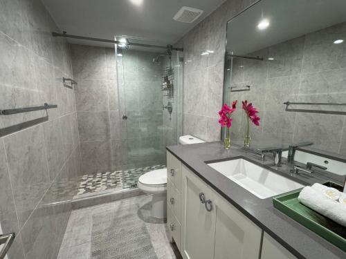 a bathroom with a sink and a toilet and a shower at Modern Apartments Ocean Reserve Sunny Isles Beach in Sunny Isles Beach