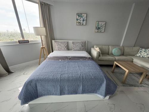 a bedroom with a bed and a couch at Modern Apartments Ocean Reserve Sunny Isles Beach in Sunny Isles Beach