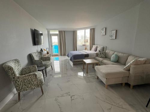a living room with a couch and a bed at Modern Apartments Ocean Reserve Sunny Isles Beach in Sunny Isles Beach