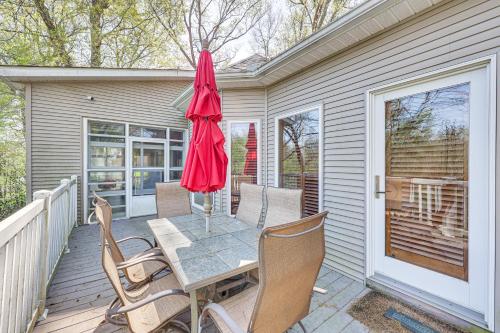 a patio with a table and chairs and an umbrella at Private Dock The River House in Heber Springs! in Heber Springs