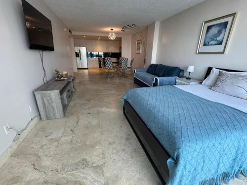 a bedroom with a bed and a living room at Modern Apartments Ocean Reserve Sunny Isles Beach in Sunny Isles Beach