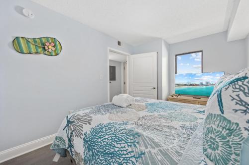 a bedroom with a bed with a view of the ocean at Family-Friendly Oceanfront Condo at Compass Cove Resort in Myrtle Beach in Myrtle Beach