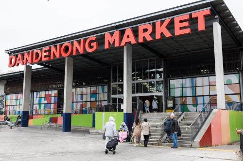 a group of people walking in front of a market at Holiday Inn Dandenong by IHG in Dandenong