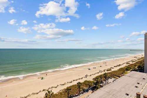a view of the beach from the balcony of a condo at Family-Friendly Oceanfront Condo at Compass Cove Resort in Myrtle Beach in Myrtle Beach