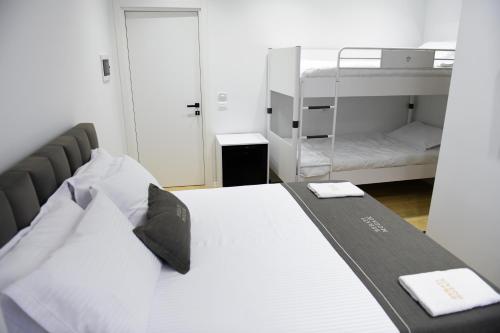 a bedroom with a bed and a bunk bed at Berati Mozaik Hotel in Berat