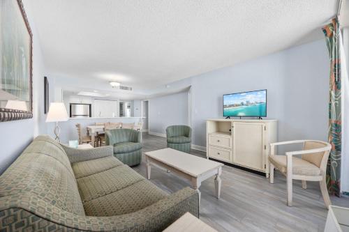a living room with a couch and a table at Charming 3BR 2BA Oceanfront Condo in Myrtle Beach