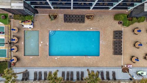 an overhead view of a swimming pool on a building at Charming 3BR 2BA Oceanfront Condo in Myrtle Beach