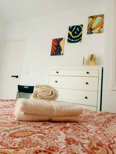 a bedroom with a bed with a dresser and a bedspread at House in the heart of Dos Hermanas in Dos Hermanas