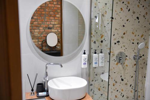 a bathroom with a sink and a mirror at Berati Mozaik Hotel in Berat