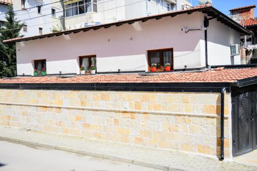 a brick wall in front of a house at Berati Mozaik Hotel in Berat