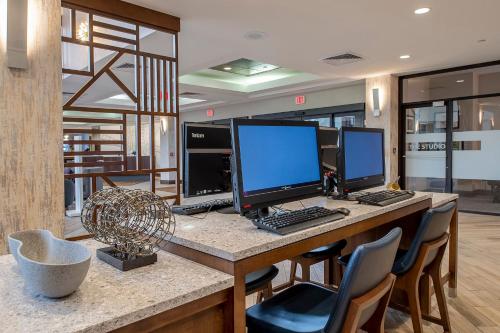 a desk with two computer monitors on top of it at Crowne Plaza Hotel St. Louis Airport by IHG in Bridgeton