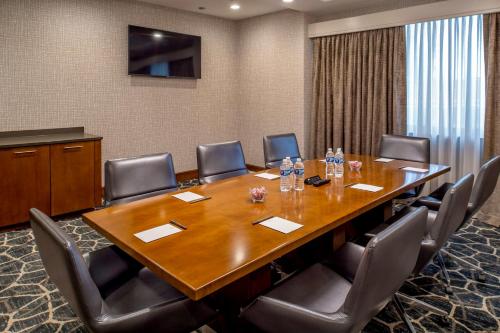a conference room with a large wooden table and chairs at Crowne Plaza Hotel St. Louis Airport by IHG in Bridgeton