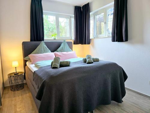a bedroom with a bed with two teddy bears on it at Fuchsbau mit Kamin & Terrasse & Garten in Winterberg