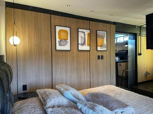 a bedroom with wooden walls and a bed with pillows at Apto de lujo con jacuzzi in Santa Rosa de Cabal