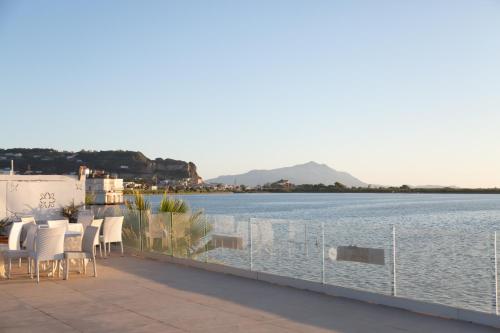 a balcony with chairs and a view of a body of water at Villa Edelweiss in Bacoli