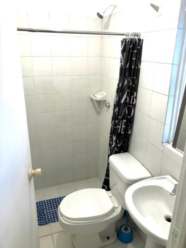 a bathroom with a toilet and a sink at RMS Hostal - Condesa in Mexico City