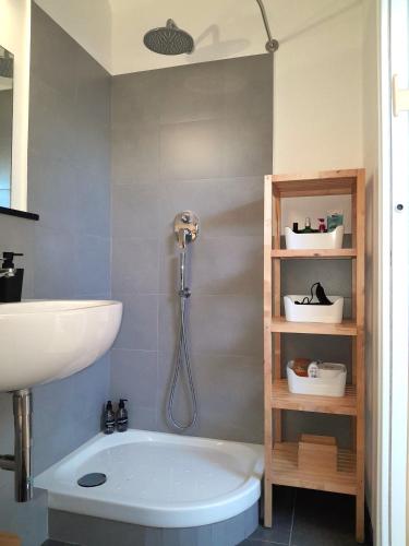 a bathroom with a shower and a sink and a tub at Attico sul Mare By Smart-Home in Genova