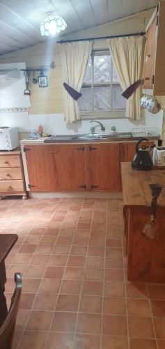a kitchen with a sink and a counter top at Woiworung Cottage-BYO bed linen and towels-NO WIFI- take a step back in time in Gisborne