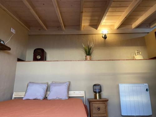 a bedroom with a bed and a night stand with a lamp at Casa Garcia-Mar in Los Quemados