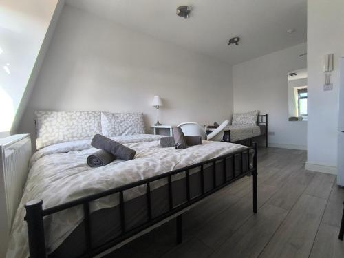 a bedroom with a bed with pillows on it at Tooting Broadway Family Suite in London