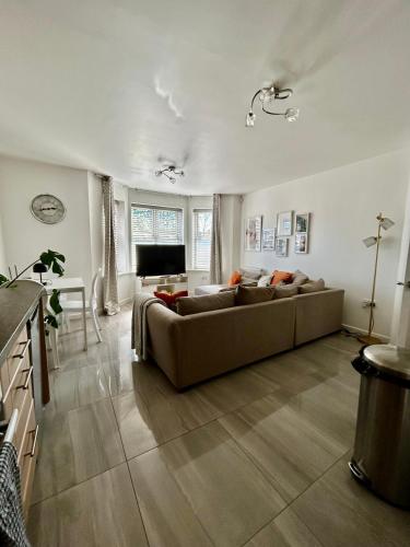 a large living room with a couch and a television at Modern 2 Bed Apartment With Free Parking And Netflix in Dawley