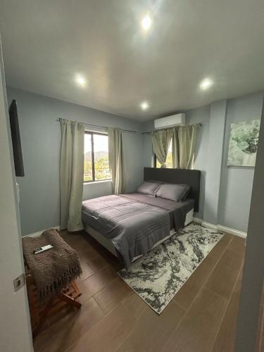 a bedroom with a bed and a window at Serene Sunset Escape in Castries