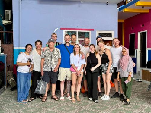 a group of people posing for a picture in front of a house at Homestay Lidiya in Banyuwangi