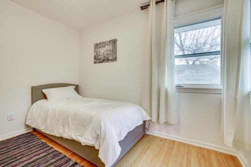 a white bedroom with a bed and a window at Waterfront Eagle Lake Home with Yard and Deck in Maple Grove
