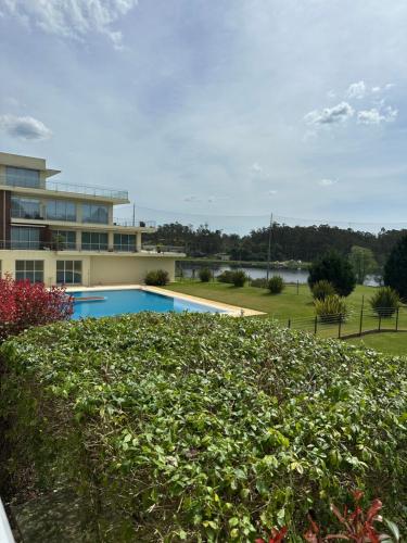 a swimming pool in front of a building at Studio Luxury Quinta da Barca in Esposende