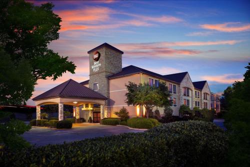 a building with a clock tower on top of it at Best Western Plus Lewisville Flower Mound in Lewisville