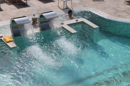 a swimming pool with water shooting out of it at Terme Villa Pace in Abano Terme
