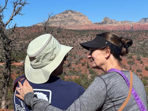 a woman standing next to a woman looking at a mountain at Cathedral Casita at Sedona Cathedral Hideaway LLC in Sedona