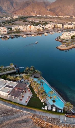 an aerial view of a resort with a body of water at The Beach House in Muscat