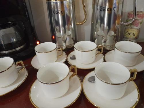 a group of tea cups and saucers on a table at Irupe poty in Puerto Iguazú