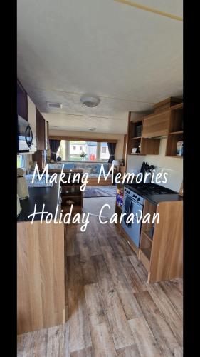 a kitchen with wood flooring in a house at Making Memories Holiday Caravan in Skegness