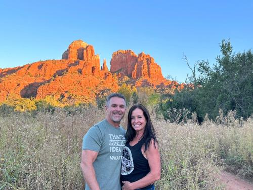 a man and a woman standing in front of a mountain at Cathedral Casita at Sedona Cathedral Hideaway LLC in Sedona
