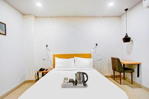 a bedroom with a white bed with a blender on it at Townhouse Volga Homes in Guwahati