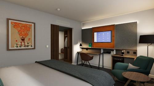 a hotel room with a bed and a television at Holiday Inn London Bloomsbury by IHG in London
