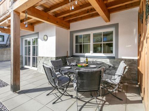 a patio with a table and chairs on it at Residenz Edelalm TOP 1 in Lauterbach