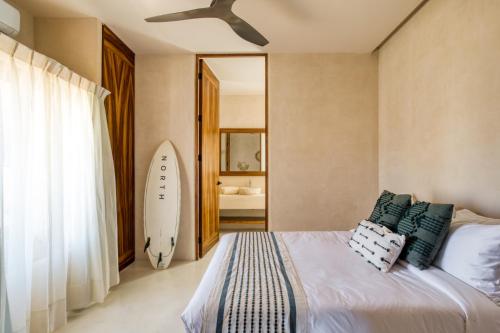 a bedroom with a bed and a surfboard in it at Amina Wind Resort by Tasman in Salinas