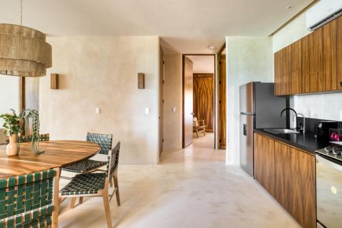 a kitchen and dining room with a wooden table and chairs at Amina Wind Resort by Tasman in Salinas