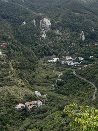a view of a mountain with houses and trees at Casa Rural Chamorga - Pensión - Guesthouse - in Santa Cruz de Tenerife