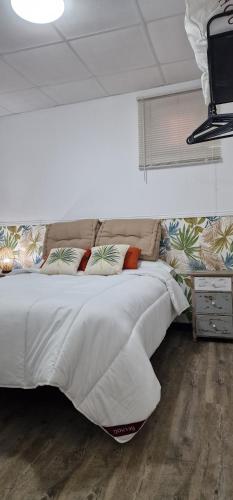 a bedroom with a large bed with white sheets and pillows at Porto A Guarda in A Guarda