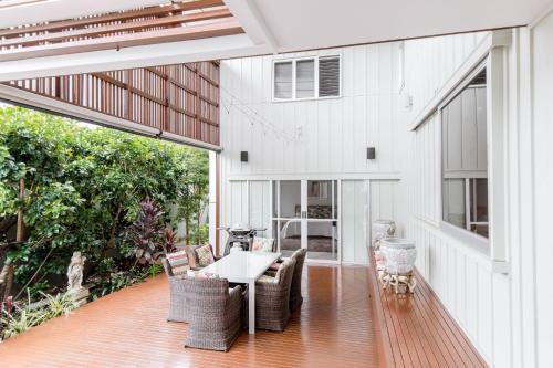 an outdoor patio with a table and chairs at Frida - Elysium in Noosa Heads