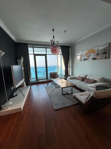 a living room with a couch and a tv at sand and beach haven at Ajman Corniche! in Dubai