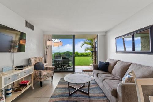 a living room with a couch and a table at KIHEI BEACH, #109 condo in Kihei