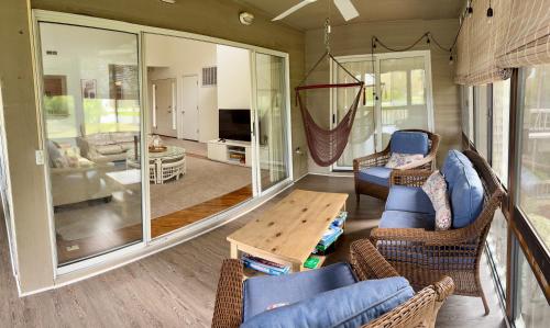 a living room with chairs and a table at Elegant 3-Bedroom Condo in Lewes with Pond Views in The Plantations